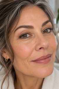 Woman in her early 50s with full fluffy brushed-up natural eyebrows